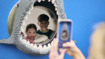 Kids Looking Through LEGO Shark Head At Coastguard HQ