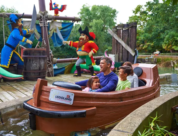 Family with LEGO models on Pirate Falls log flume at the LEGOLAND® Windsor Resort