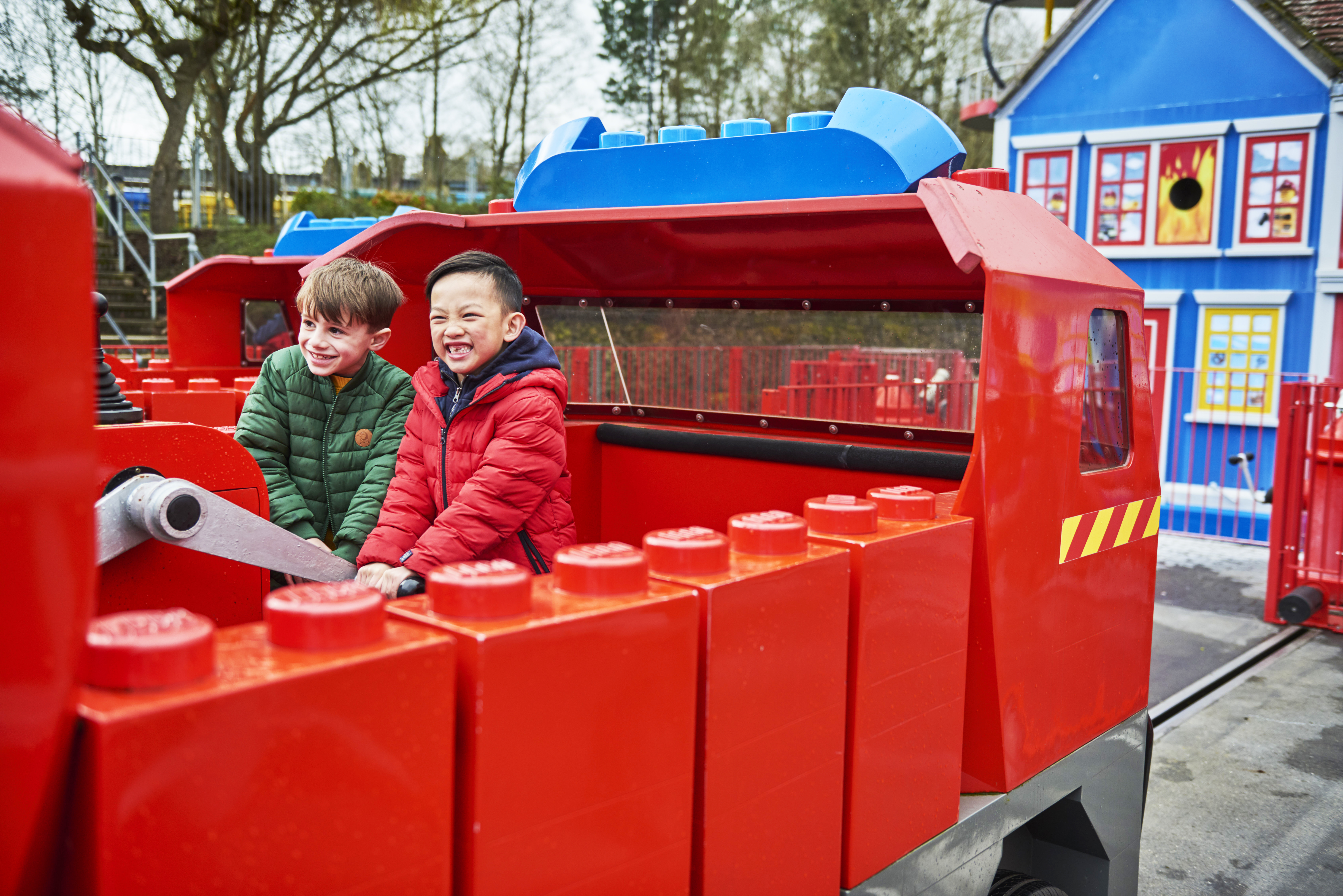 Boys smiling and laughing on Fire Academy at the LEGOLAND Windsor Resort