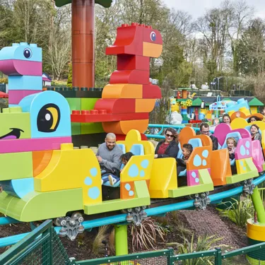 Families riding DUPLO® Dino Coaster at the LEGOLAND® Windsor Resort