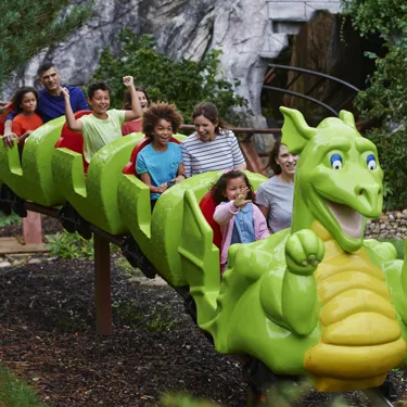 Families smiling on Dragon's Apprentice at the LEGOLAND Windsor Resort