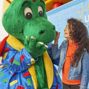 Girl laughing with Ollie the Dragon at the LEGOLAND Windsor Resort