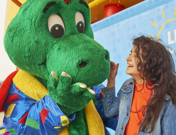 Girl laughing with Ollie the Dragon at the LEGOLAND Windsor Resort