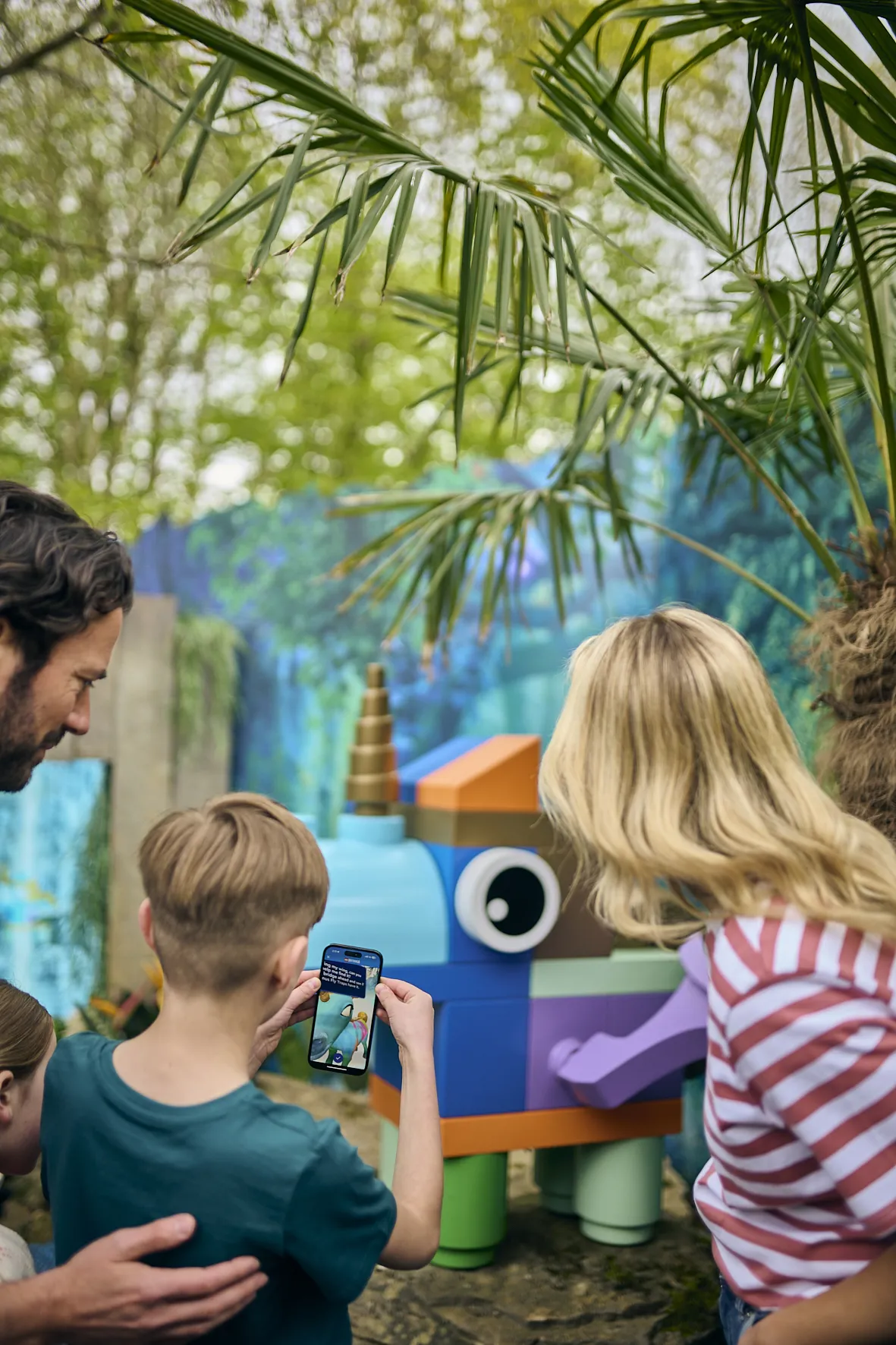 Family scanning Bitsandbobs with the Augmented Reality feature of The Magical Forest