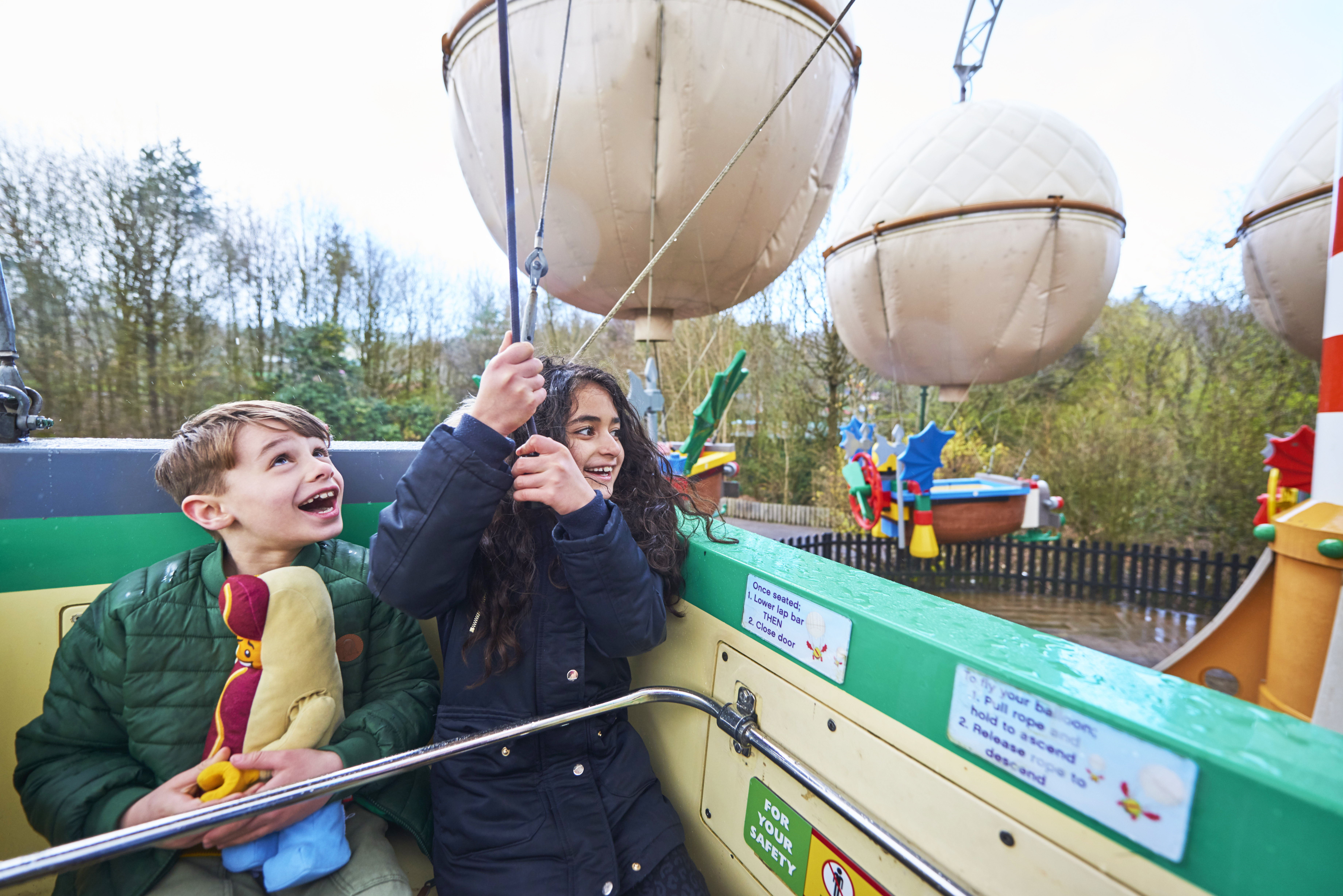 Girl and boy looking up and smiling on Balloon School at the LEGOLAND Windsor Resort