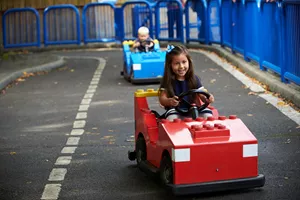 Girl and boy driving cars at L-Drivers at the LEGOLAND Windsor Resort