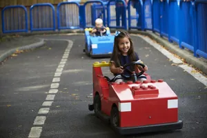 Girl and boy driving cars at L-Drivers at the LEGOLAND Windsor Resort