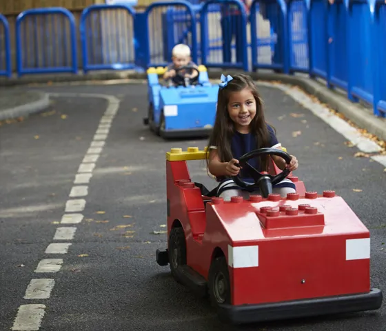 Girl and boy driving cars at L-Drivers at the LEGOLAND Windsor Resort