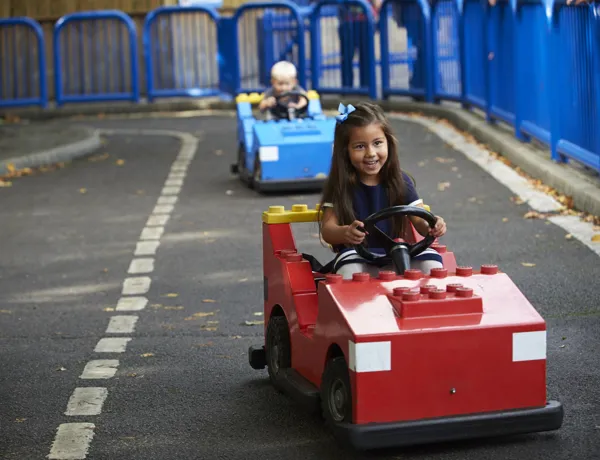 Girl and boy driving cars at L-Drivers at the LEGOLAND Windsor Resort
