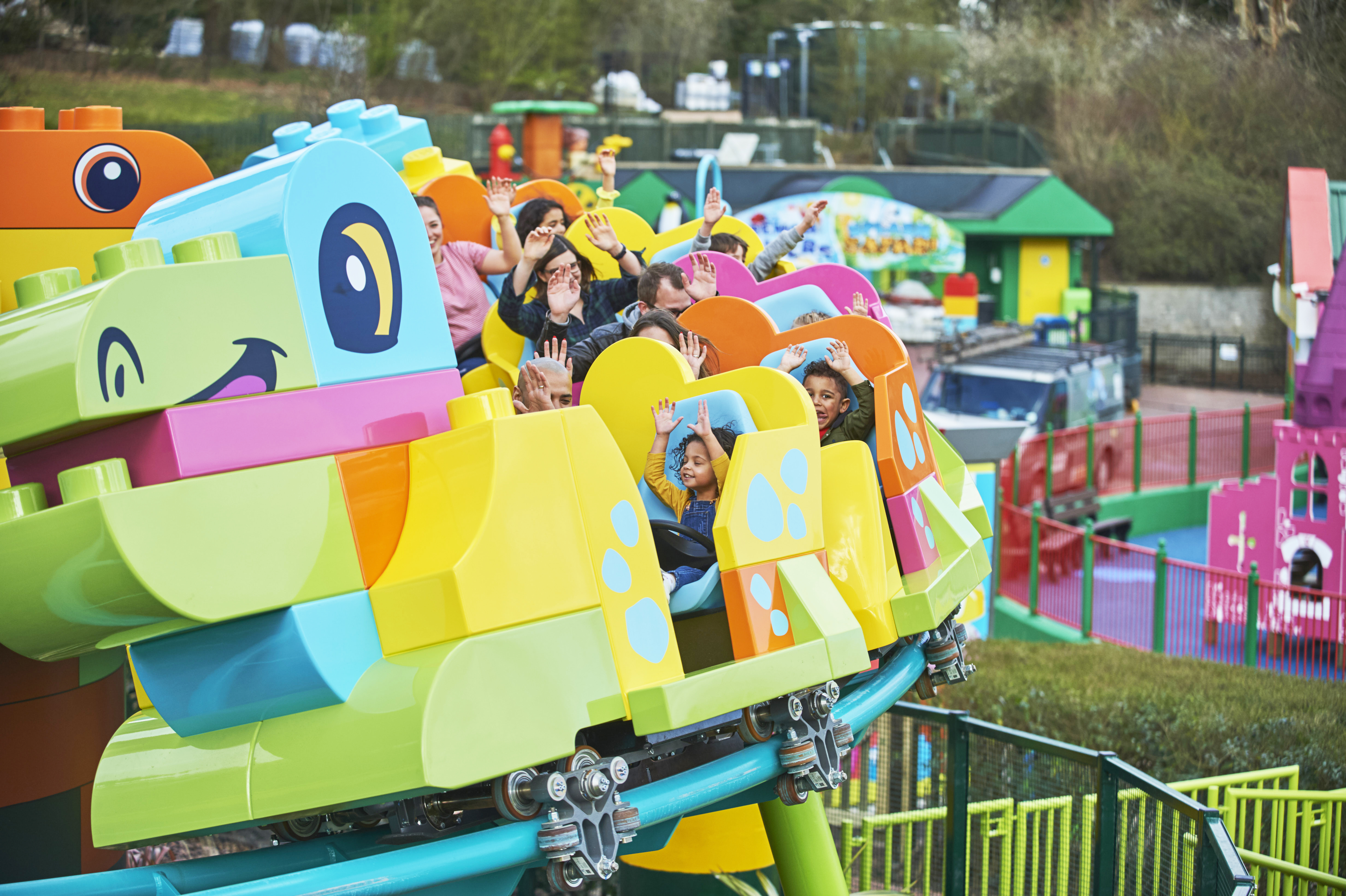 Families riding DUPLO® Dino Coaster at LEGOLAND® Windsor Resort