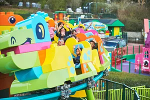 Families riding DUPLO® Dino Coaster at LEGOLAND® Windsor Resort