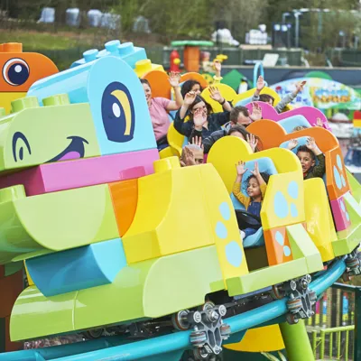 Families riding DUPLO® Dino Coaster at LEGOLAND® Windsor Resort