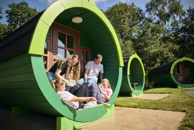 Family Outside Of A Woodland Barrel At The LEGOLAND Windsor Resort Woodland Village