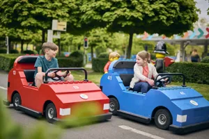 2 children driving LEGO cars