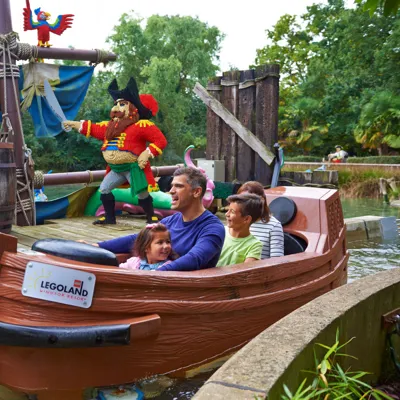 Family with LEGO models on Pirate Falls log flume at the LEGOLAND® Windsor Resort