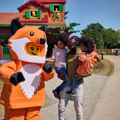 Family meeting Fox Girl outside of the LEGOLAND Woodland Village Clubhouse