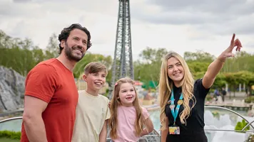 Family with VIP host looking at models in Miniland