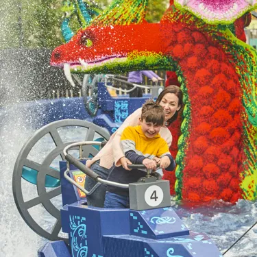 Adult & child getting splashed on Hydra's Challenge in LEGO MYTHICA