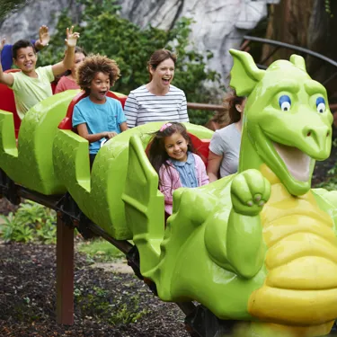 Families smiling on Dragon's Apprentice at the LEGOLAND Windsor Resort