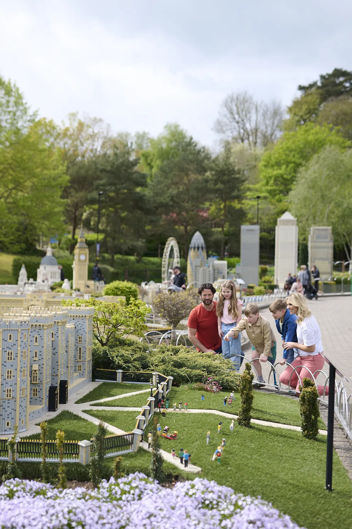 Family looking and pointing at LEGO model of Windsor Castle in Miniland