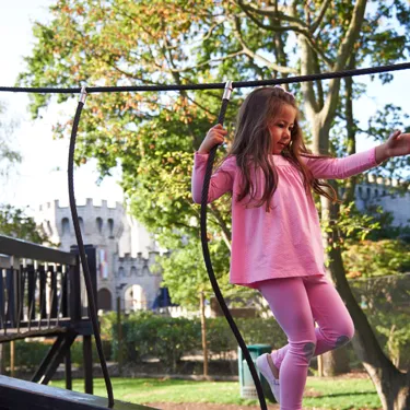 Girl playing in Castaway Camp playground