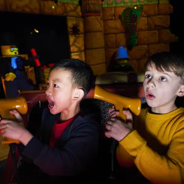 Boys shooting targets in Laser Raiders