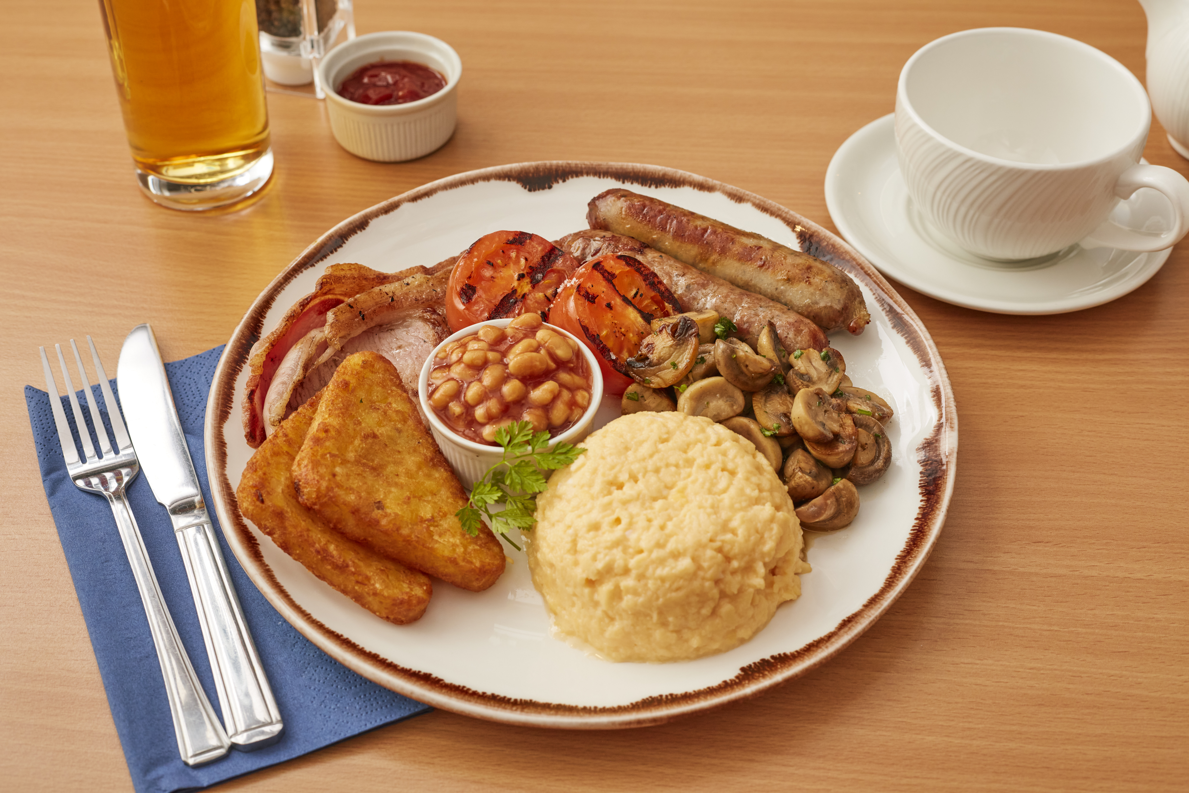 Breakfast at BRICKS Restaurant - Scrambled Egg, Hash Browns, Baked Beans, Sausages, Bacon, Mushrooms and Grilled Tomato