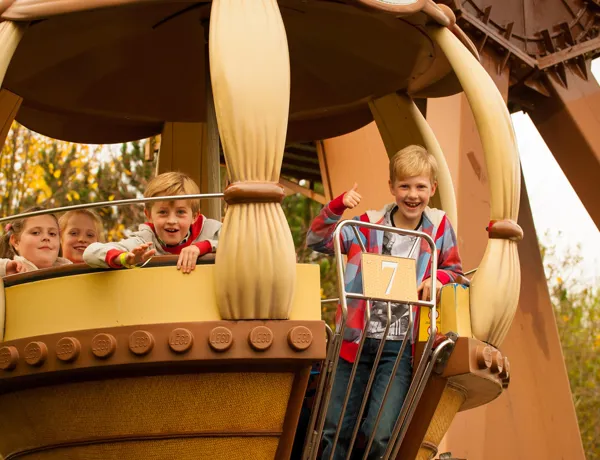Children riding Aero Nomad ferris wheel in Kingdom of the Pharaohs