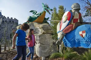 Boy and girl with LEGO model of Knight and Dragon