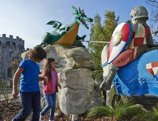 Boy and girl with LEGO model of Knight and Dragon