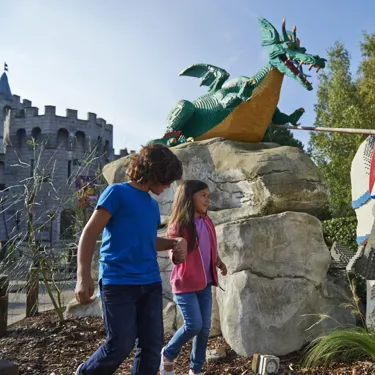 Boy and girl with LEGO model of Knight and Dragon