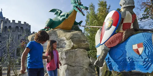 Boy and girl with LEGO model of Knight and Dragon