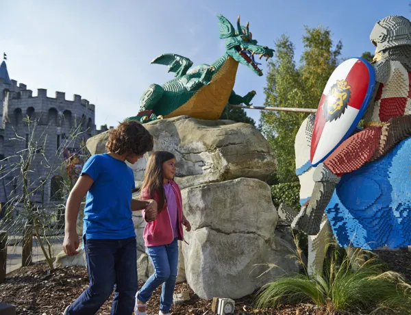 Boy and girl with LEGO model of Knight and Dragon
