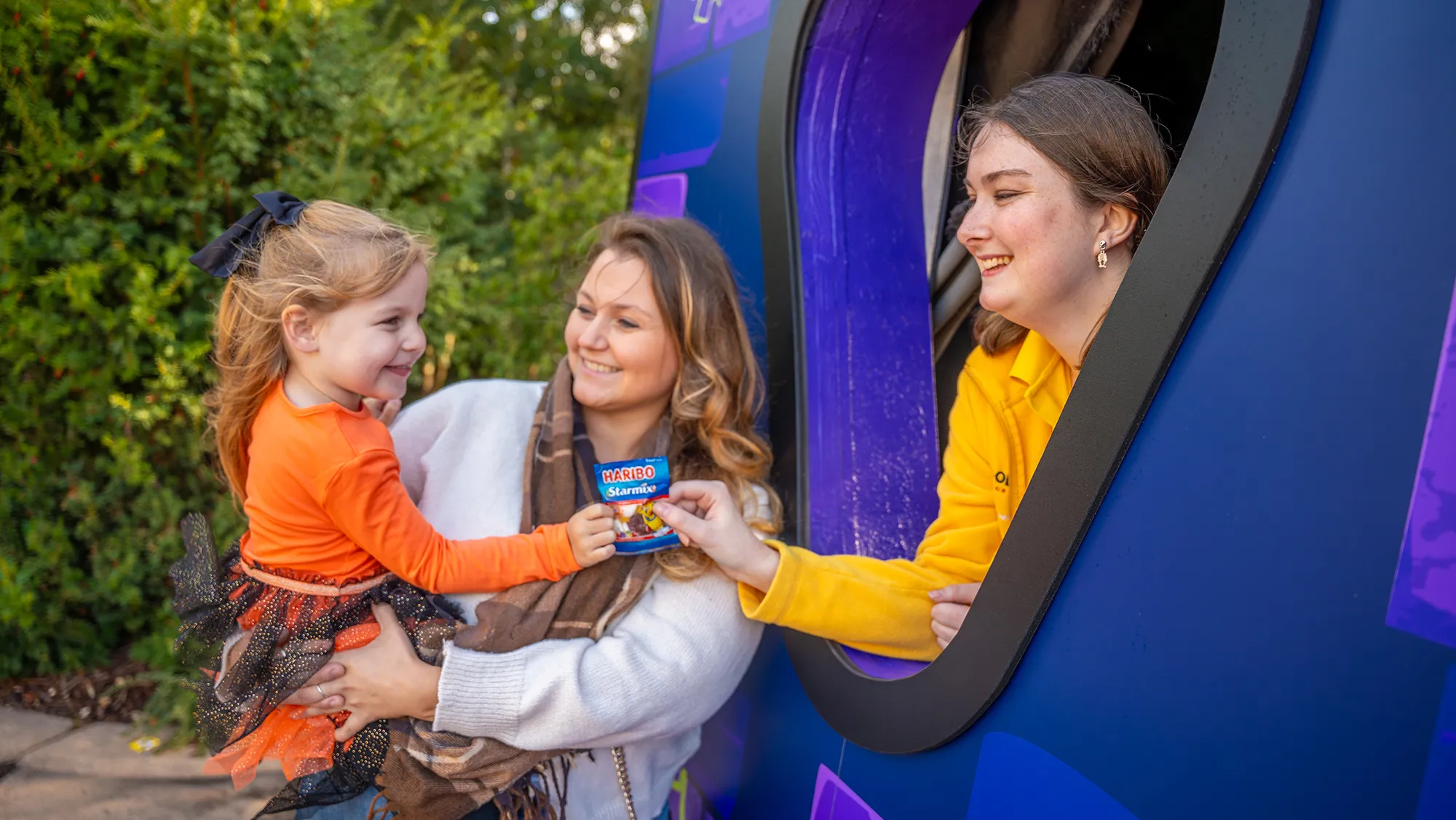 Family At Trick Or Treat Stops