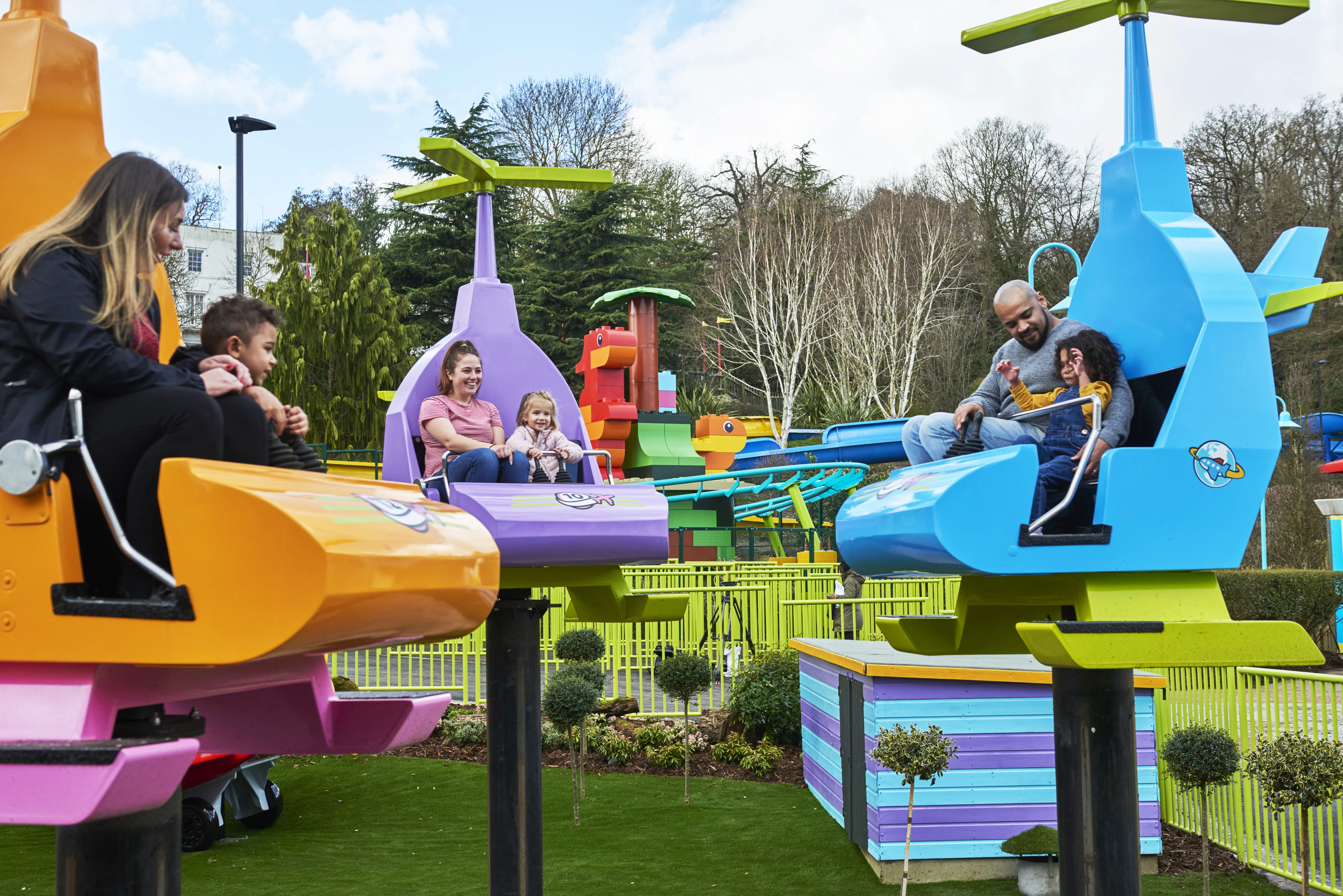 Three families laughing and smiling on DUPLO Valley Airport