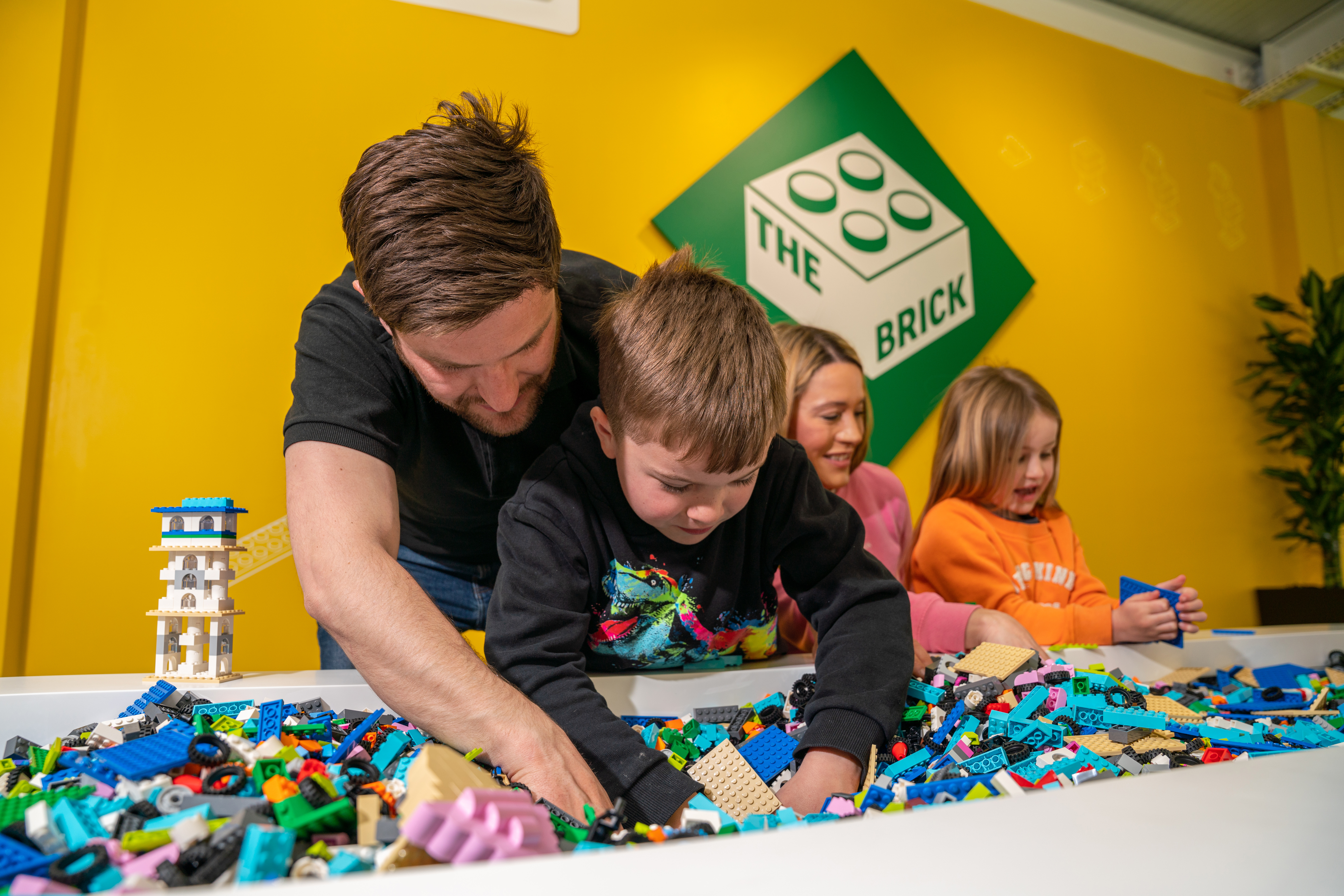 Families building with LEGO bricks in The Brick