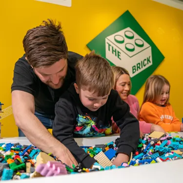 Families building with LEGO bricks in The Brick