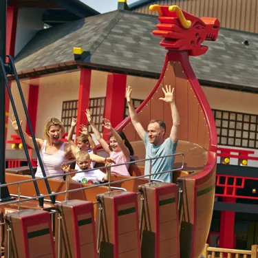 Family smiling with arms in the air on Destiny's Bounty