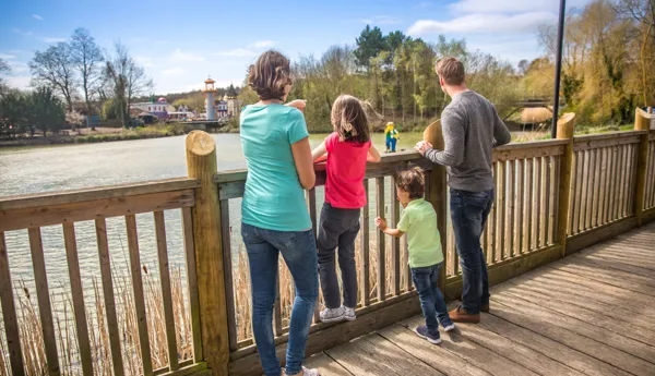 Family looking out to the Theme Park on the boardwalk outside of the LEGOLAND Resort Hotels