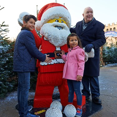 Family with LEGO model of Father Christmas at LEGOLAND at Christmas at the LEGOLAND Windsor Resort