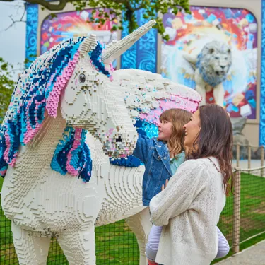 Mother and daughter looking at LEGO model of an Alicorn