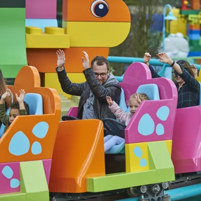 Families riding DUPLO® Dino Coaster at the LEGOLAND® Windsor Resort