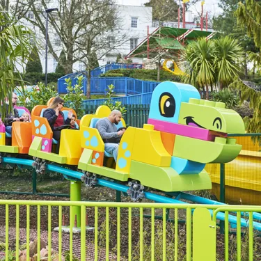 Families riding DUPLO® Dino Coaster at the LEGOLAND® Windsor Resort