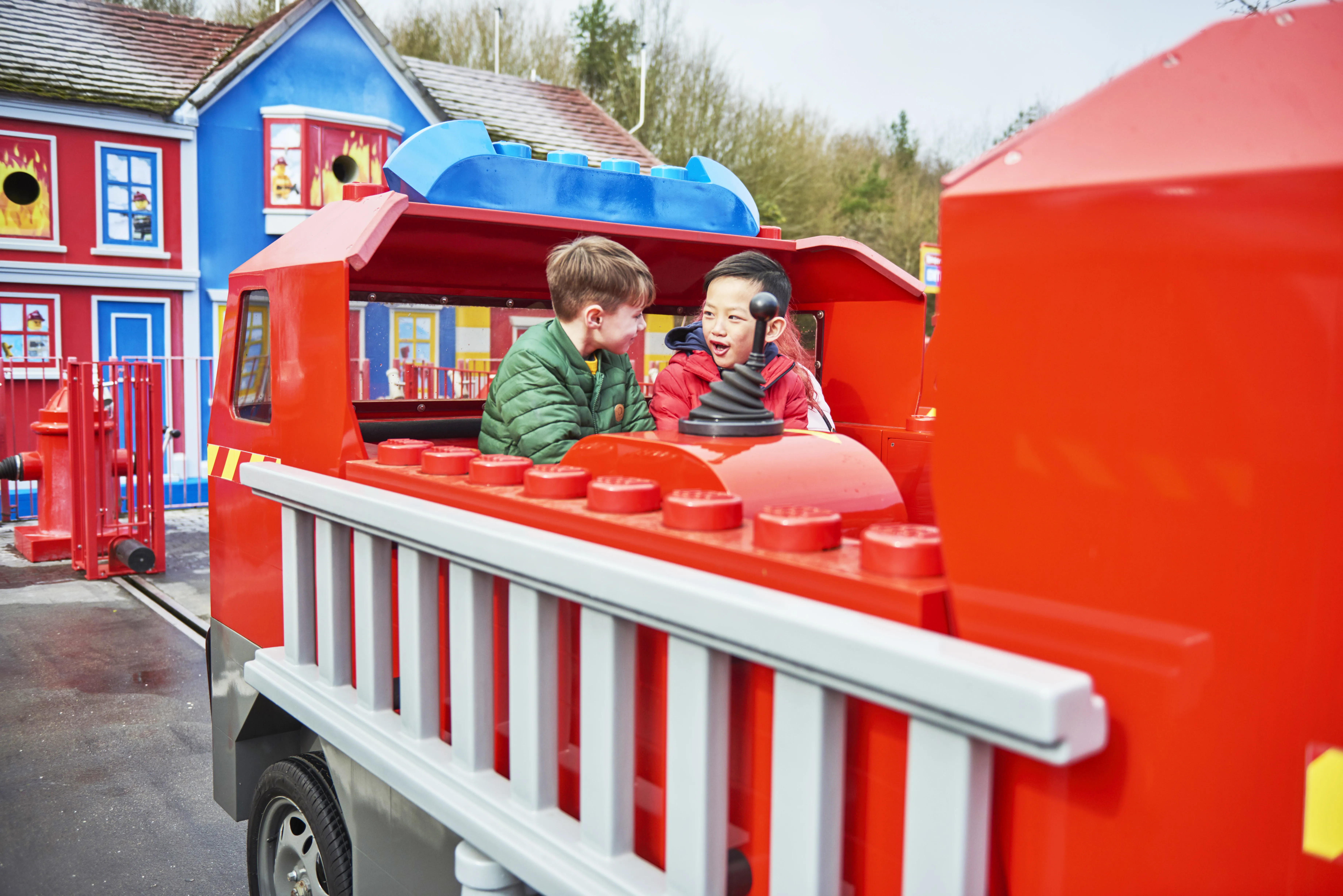 Boys laughing and looking at each other on Fire Academy at the LEGOLAND® Windsor Resort