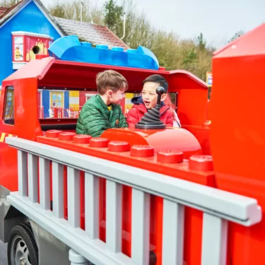 Boys laughing and looking at each other on Fire Academy at the LEGOLAND® Windsor Resort