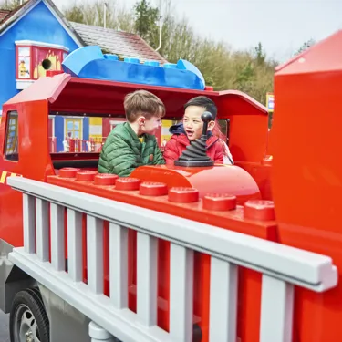 Boys laughing and looking at each other on Fire Academy at the LEGOLAND® Windsor Resort
