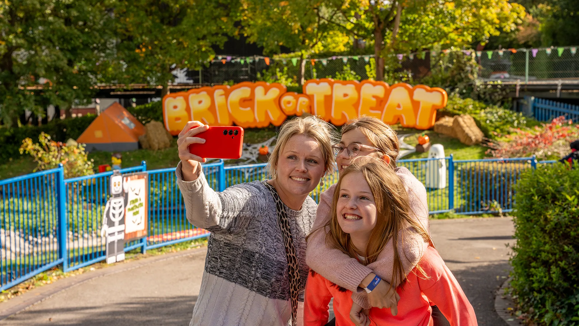 Family In Front Of Brick Or Treat Sign