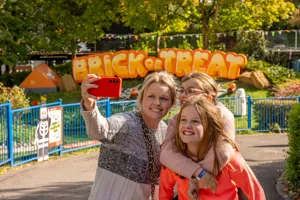 Family In Front Of Brick Or Treat Sign