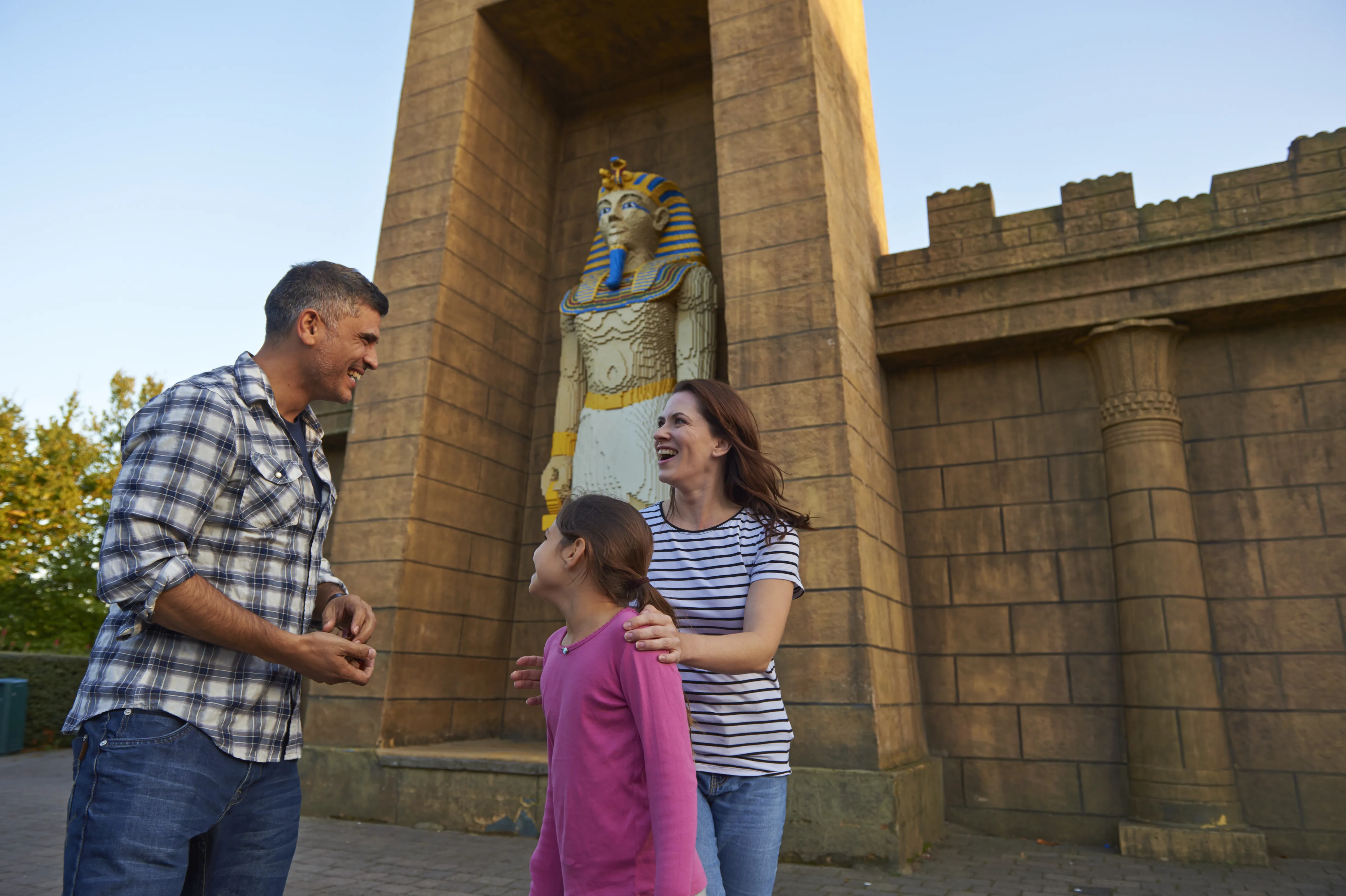 Family next to large Pharaoh model in Kingdom of the Pharaohs