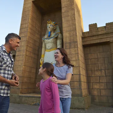 Family next to large Pharaoh model in Kingdom of the Pharaohs